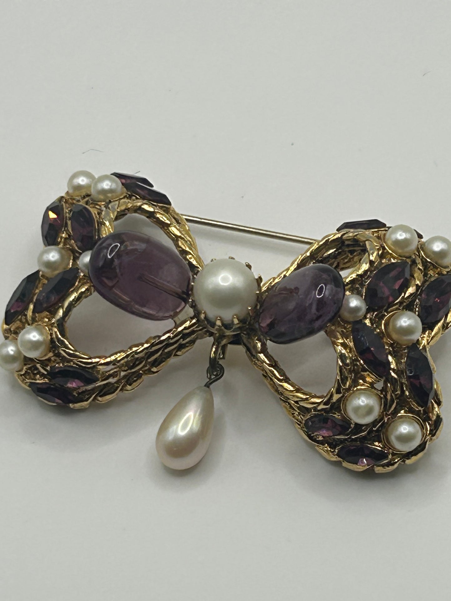 Pretty Vintage Brooch Signed Adrian Mann Bow with Amethyst Stones.